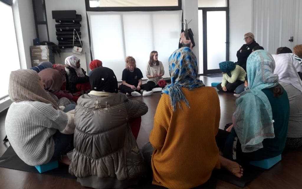 Group of Women sit together in a circle at a Legal Workshop
